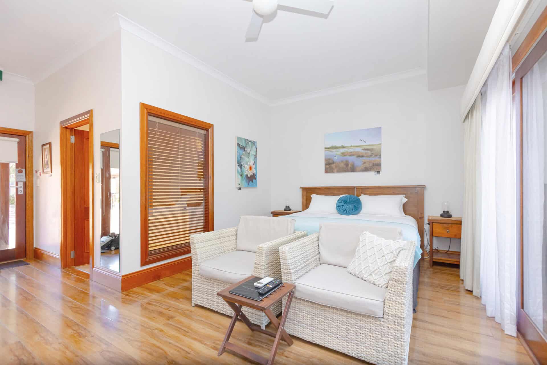 Motel room with King bed and seating area.