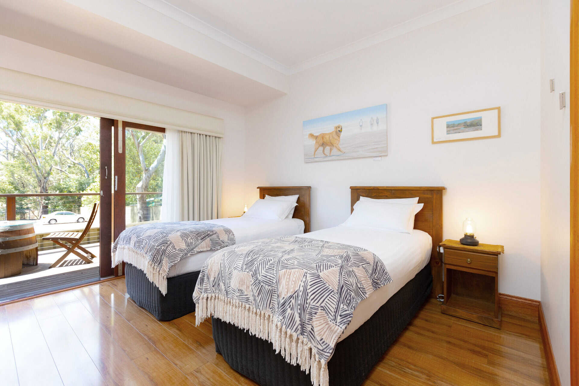 Twin room with two single beds and balcony doors.