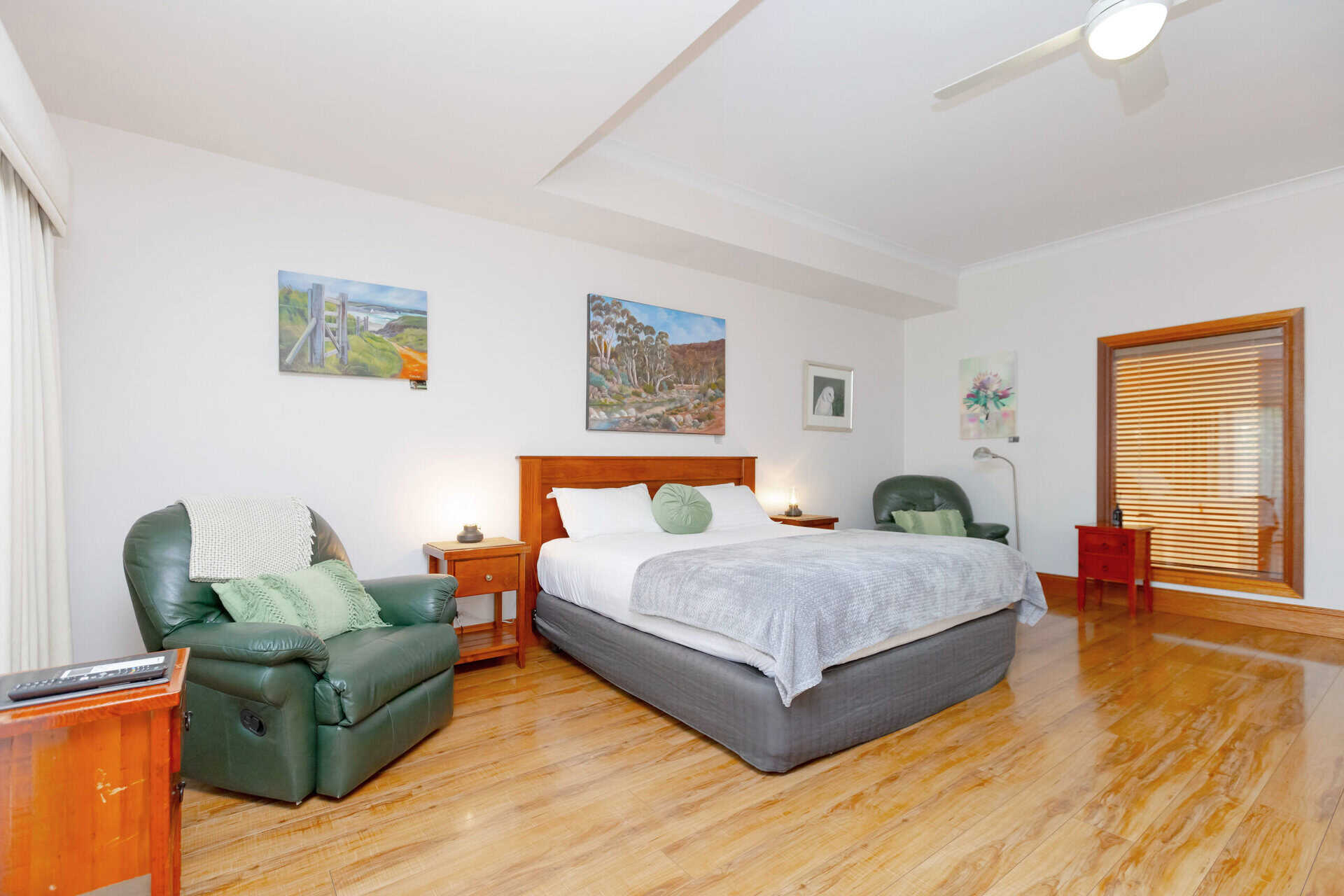 Motel room with King bed and recliner chairs.