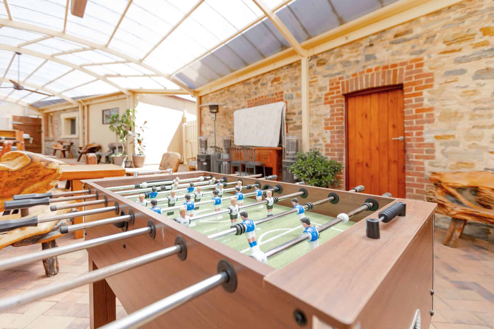 Covered outdoor area with table soccer and seating.