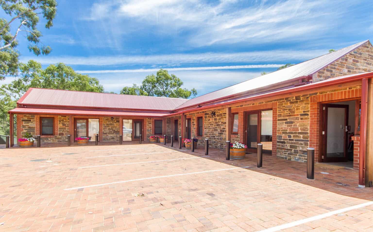 Birdwood Motel courtyard with parking, guest room entrances and outdoor seating.